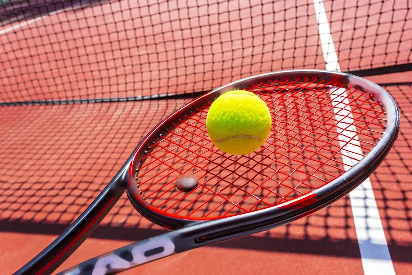 Tennis balls and racket on the court