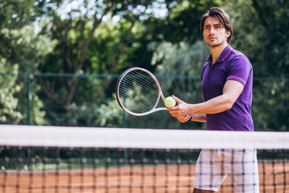 Man playing tennis on court